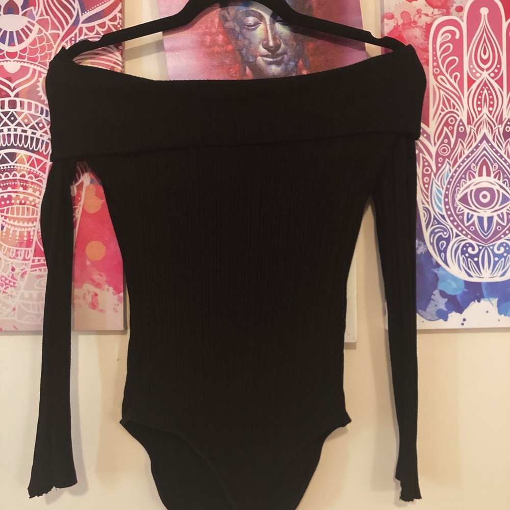 Off shoulder black shirt with long sleeves.